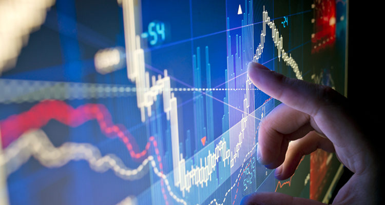 Stock Market Data - A city worker Analysing stock market data on a monitor.